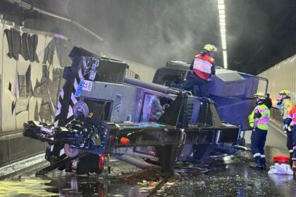 Overturned crane on Sydney M5 Motorway with emergency crews at the scene