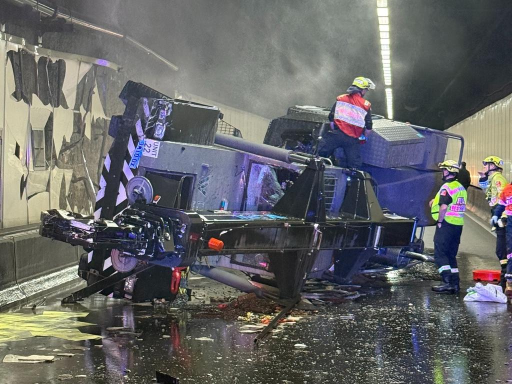 Overturned crane on Sydney M5 Motorway with emergency crews at the scene
