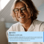 Man looking at laptop and chuckling at donation banner