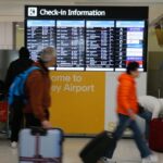 Flight attendants restrain unruly wine-drinking passenger on descent into Sydney
