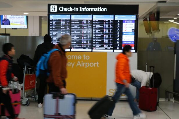 Flight attendants restrain unruly wine-drinking passenger on descent into Sydney