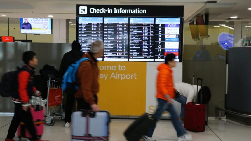 Flight attendants restrain unruly wine-drinking passenger on descent into Sydney