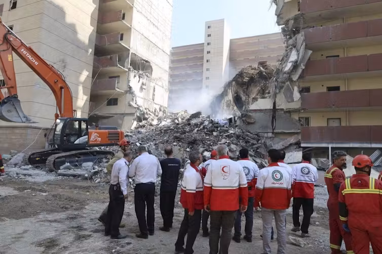 Iranian Red Crescent Society rescuers at the scene of an Israeli strike in Tehran