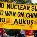 Protesters in Australia holding anti-war banners