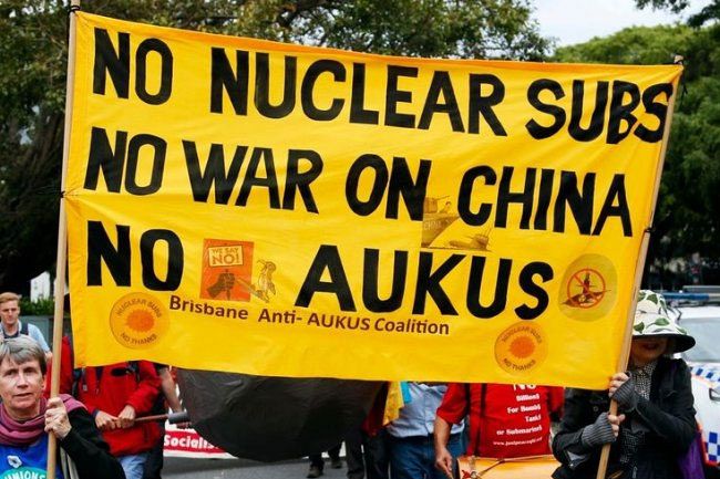 Protesters in Australia holding anti-war banners