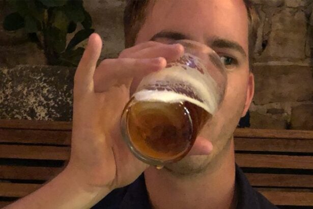 Person holding a cold beer glass using the Big Sip technique