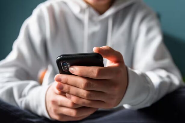 Teen using phone with facial scan