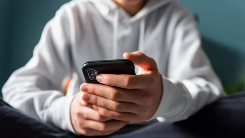 Teen using phone with facial scan