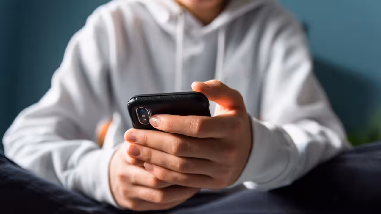 Teen using phone with facial scan