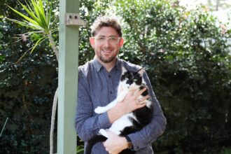 Leo Patterson Ross with his cat Louis in Turramurra home