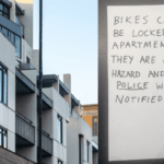 Handwritten strata notice about bike parking in lobby